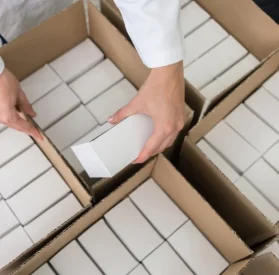 close-up of puttting subscription boxes in box