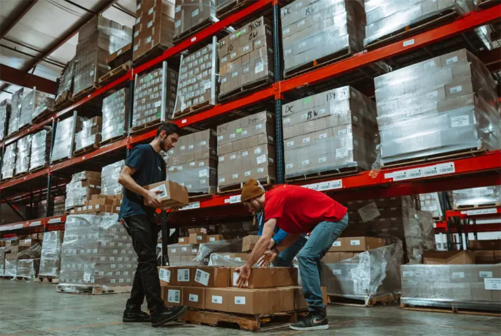gentleman picking subscription boxes up and putting them on shelf