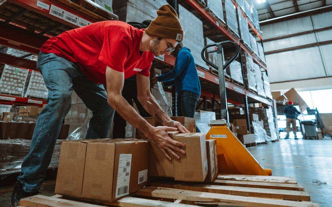 a fulfillment center employee moving boxes